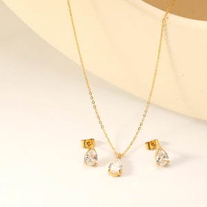 Elegant gold stainless steel jewelry set with pear-cut cubic zirconia necklace and earrings