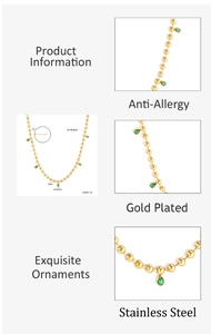 Detail of 18K gold-plated beaded necklace with green pear-cut crystal charms and measurements