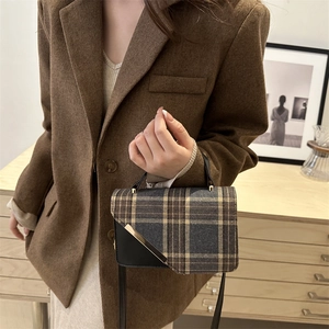 Vintage plaid shoulder bag with asymmetric flap and metal trim in retro color blocks