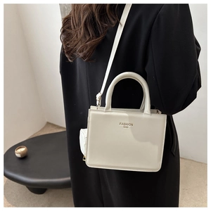 Chic cream-colored square handbag with fashion text and matching coin purse