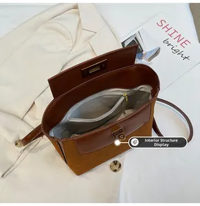 Detail view of the interior space of the vintage brown bucket bag with a zippered pocket