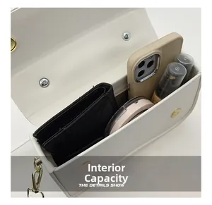 Vue de dessus de l'intérieur du sac blanc montrant le rangement pour téléphone et maquillage