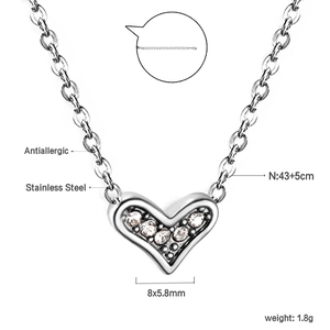 Macro detail of stainless steel heart necklace with cubic zirconia and sizing specs