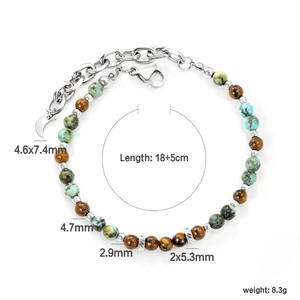 Detail of beaded bracelet with blue stones, lobster clasp, and moon pendant