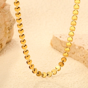 Detailed close-up of golden heart-shaped links chain necklace with polished finish