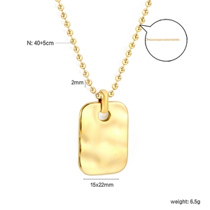 Detail of 18K gold geometric pendant necklace with hammered wave texture and 40+5cm chain