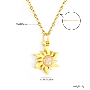 Gold sunflower pendant necklace with opal stone and cross chain on white background