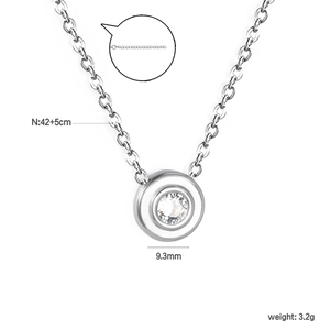 Minimalist silver circle pendant necklace with sparkling cubic zirconia on a white background