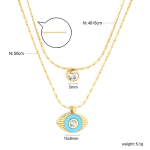 Detail of layered gold stainless steel necklaces with zircon and evil eye pendants