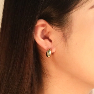 Minimalist gold teardrop stud earrings with a high-polished metallic mirror finish