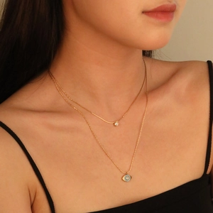Double-layer gold evil eye necklace with blue enamel and zircon charm for women