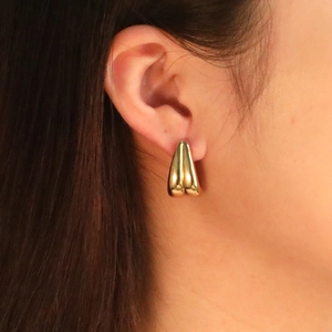 Boucles d'oreilles gouttes en acier inoxydable plaqué or 18 carats portées par un modèle
