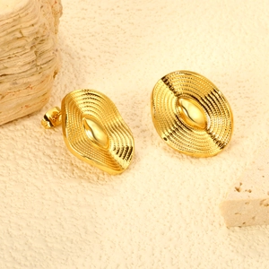 Macro view of French vintage gold oval earrings with textured concentric granular details