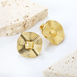 Square gold wavy stud earrings with textured ripple design on minimalist stone background
