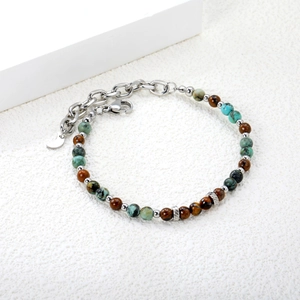 Detail of turquoise and tiger eye beaded bracelet with silver moon charm and lobster clasp