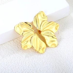 Detailed view of gold leaf flower earrings with textured ripples and metallic shine
