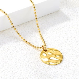 Detailed view of 18K gold plated bead chain and round hammered metal pendant