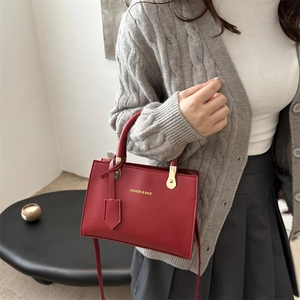 Fashion red matte leather crossbody handbag with handle and FASHION & BAGS gold lettering