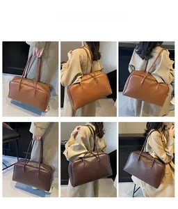 Detail view of large leather tote bags in tan and dark brown showing dual strap options