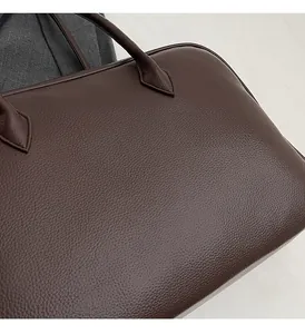 Close-up of the dark brown lychee pattern leather texture on this stylish shoulder bag