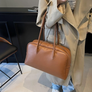 Minimalist caramel brown leather Boston tote bag with large capacity and shoulder strap