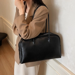 Minimalist black lychee texture large hobo bag being worn with a brown blazer outfit