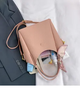 Pink bucket bag with silk scarf detail showing spacious interior for cosmetics and phone