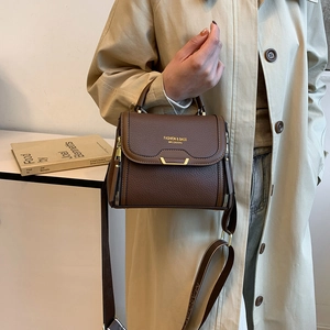 Dark brown pebble leather handbag with gold hardware and adjustable crossbody strap