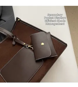 Detail view of brown leather tote bag with functional small pouch and neat stitching