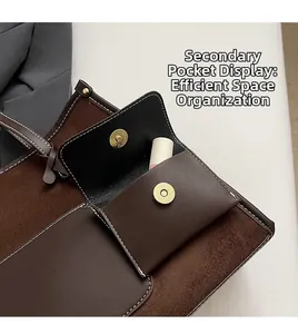 Detail view of the brown leather sub-bag with magnetic snap closure for small items
