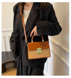 Detail of the vintage contrast stitching box bag with a golden square clasp and woven texture