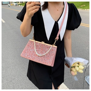 Pink sequined evening clutch with faux pearl strap and gold metal frame detailing