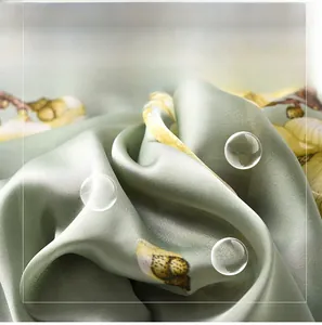 Close-up of silky magnolia scarf fabric with yellow floral print and soft textures