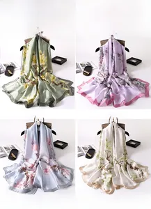 Detailed collage of silk-like floral scarves in light green, purple, blue, and beige