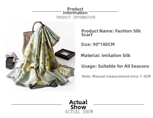 Detail of light green faux silk scarf with yellow magnolia print draped on a handbag
