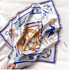 Detail of silk square scarf showing nautical patterns with anchors and ship wheels