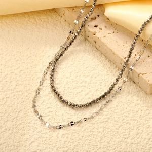 Double-layered stainless steel necklace featuring a beaded strand and sleek flat link chain