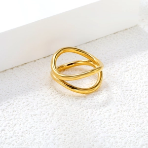 Close-up of double-layer wavy gold geometric ring with smooth metallic luster