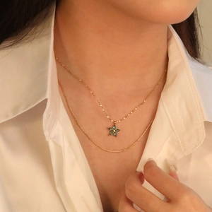 Double-layered gold flower necklace with green stones and elegant zircon pendant