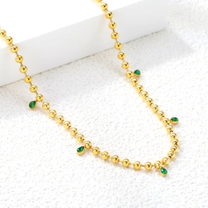 Detail of 18K gold plated beaded necklace with emerald green teardrop pendants
