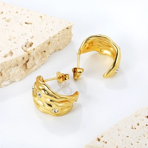 Irregular textured gold C-shaped hoop earrings with zircons on minimalist stone base
