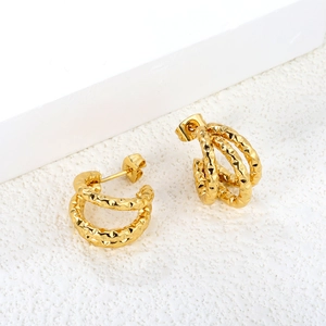 Detail of 18K gold plated C-shaped earrings with triple-layered geometric hammered texture
