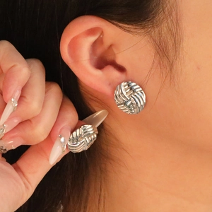 Polished silver stainless steel oval woven earrings with minimalist braided texture