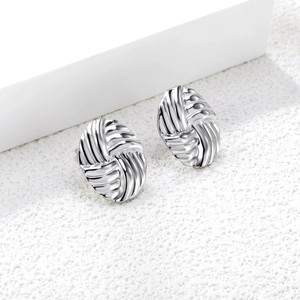 Silver oval braided textured stainless steel stud earrings shown on white display