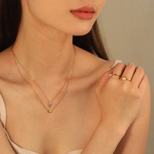 Ensemble collier double rang arête de poisson et bague coquillage doré 18 carats