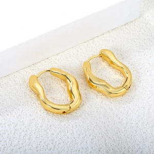Minimalist gold irregular wave hoop earrings with polished liquid metal finish on a white base