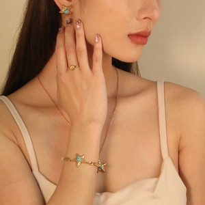 Summer beach jewelry set featuring starfish pendants and turquoise stone in gold finish