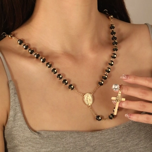 Long beaded rosary necklace with black stones, Virgin Mary medal and gold cross pendant