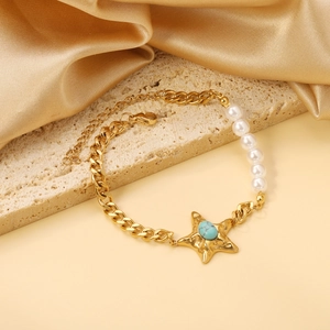 Detailed shot of golden sea star bracelet with turquoise bead and elegant white pearls