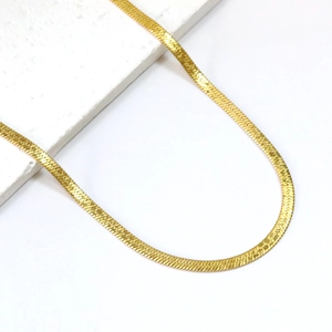 Elegant 18K gold-plated flat herringbone chain necklace on a white stone background